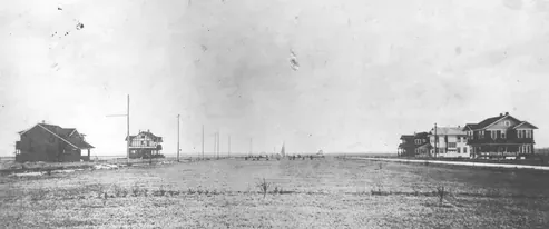 Historic black-and-white view of buildings and open land in Bellaire