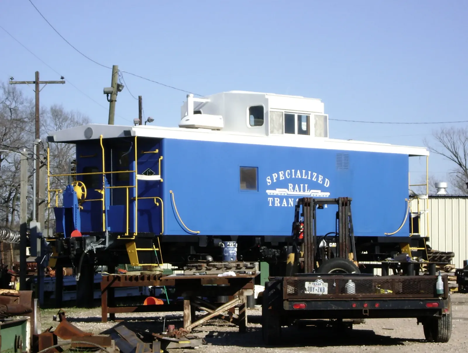 Blue railcar displayed beside a track