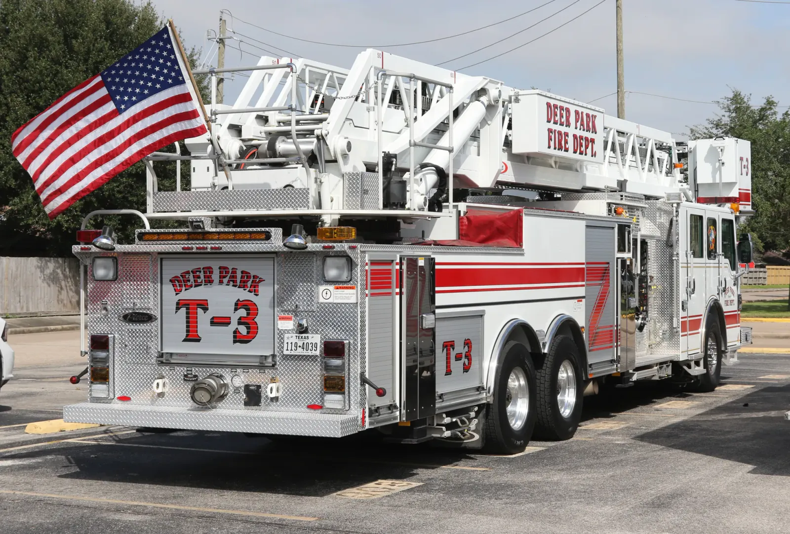 Red and white fire engine with an American flag