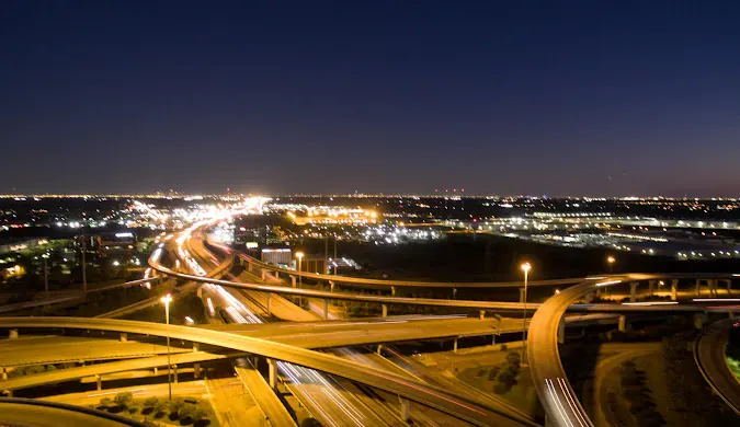 Illuminated highway interchange at night