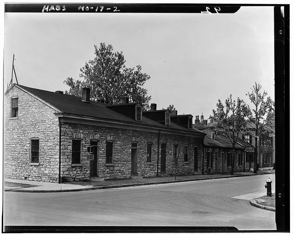 Historic black-and-white photograph of a small wooden building