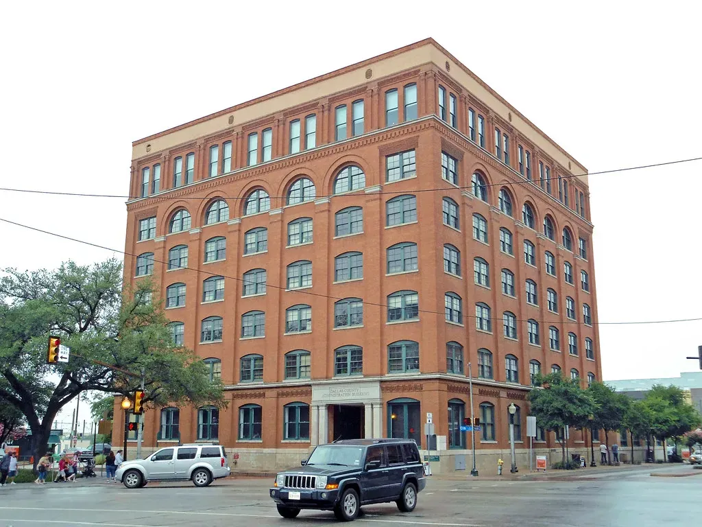 Historic red-brick multistory building on a street corner