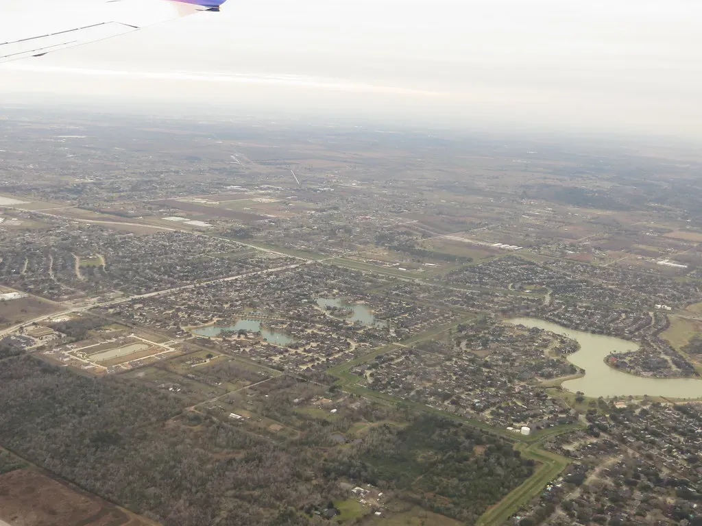 Aerial view of suburban housing and green spaces