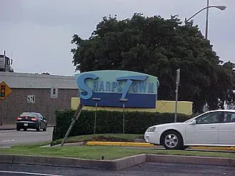 Sharpstown sign beside a road