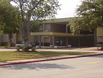 School building shaded by trees