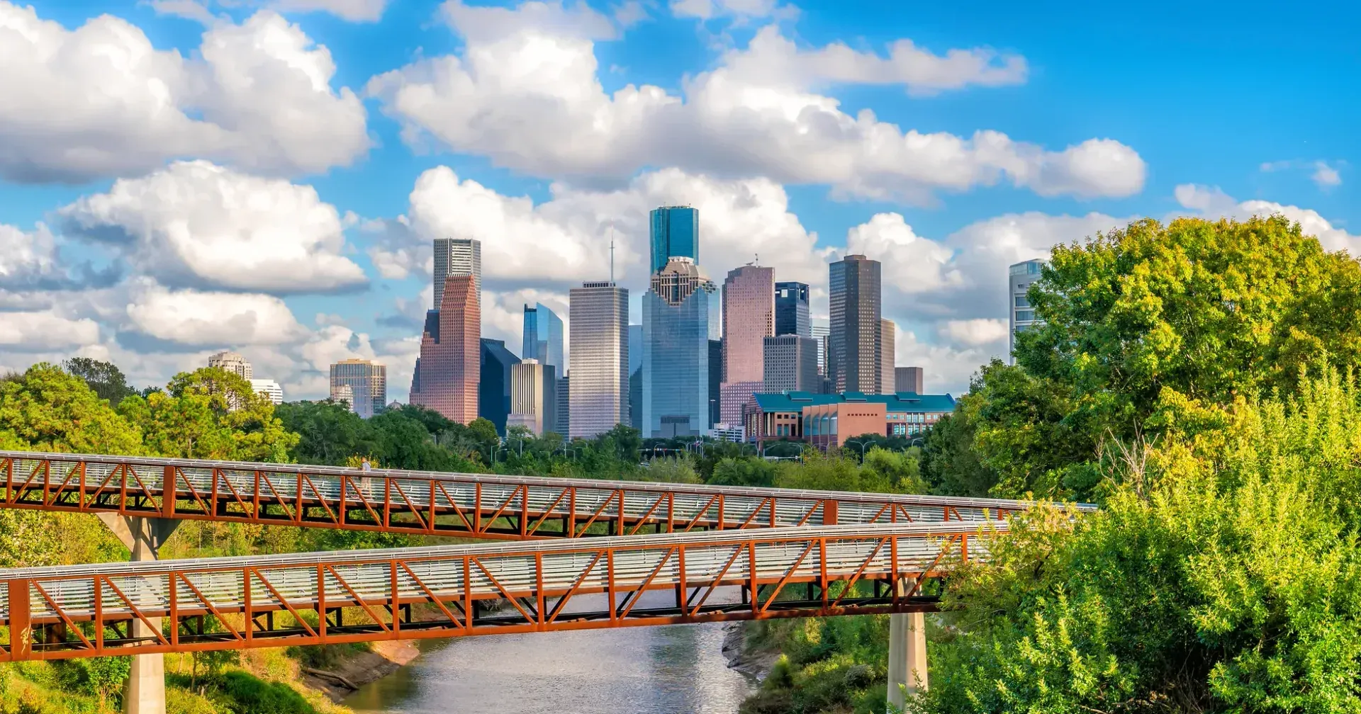 Downtown Houston skyline and Buffalo Bayou Park under a blue sky