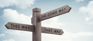Confusing direction sign with multiple arrows.