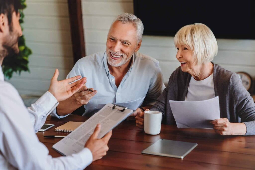Elderly couple meeting with financial advisor.