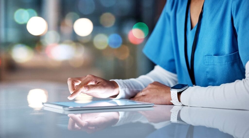 A nurse is utilizing a tablet computer in a healthcare setting.