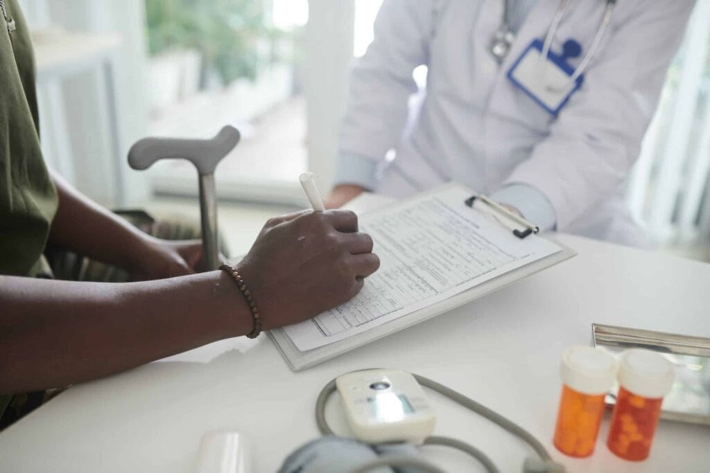 A doctor is providing medical advice on a clipboard.