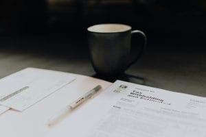 Tax withholding paperwork highlighting group health insurance tax benefits for small businesses.